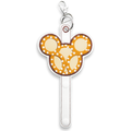 A holder with a Mickey Mouse pretzel-inspired design, predominantly white with gold details, attached to a snap closure and a lobster clip for carrying.